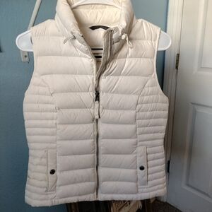 White quilted puffer vest with high collar and full-length zipper
